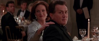 Movie still from “The American President” (1995), directed by Rob Reiner – An older man and a younger woman are posing for a picture; Close Up shot, Low angle