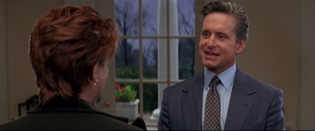 Movie still from “The American President” (1995), directed by Rob Reiner – A man in a suit and tie talking to a woman; Close Up shot, Over the shoulder angle