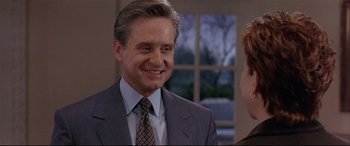 Movie still from “The American President” (1995), directed by Rob Reiner – A man wearing a suit and tie talking to a woman; Close Up shot, Over the shoulder angle