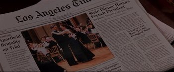 Movie still from “The American President” (1995), directed by Rob Reiner – A newspaper with a picture of a couple dancing; Extreme Close Up shot, High angle