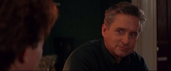 Movie still from “The American President” (1995), directed by Rob Reiner – A person sitting at a table; Close Up shot, Over the shoulder angle