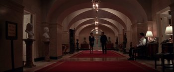 Movie still from “The American President” (1995), directed by Rob Reiner – A man and a woman are walking in a hallway; Wide shot, Low angle
