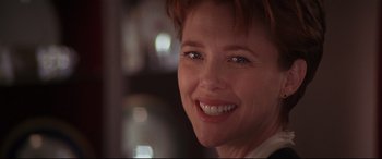 Movie still from “The American President” (1995), directed by Rob Reiner – A person with a smile on their face; Close Up shot, Low angle