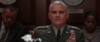 Movie still from “The American President” (1995), directed by Rob Reiner – An older man in a military uniform is sitting in front of a clock; Close Up shot, Low angle