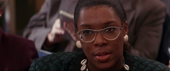 Movie still from “The American President” (1995), directed by Rob Reiner – A person wearing glasses; Close Up shot, Over the shoulder angle