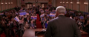 Movie still from “The American President” (1995), directed by Rob Reiner – A man is giving a speech in front of a crowd; Wide shot, High angle