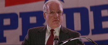 Movie still from “The American President” (1995), directed by Rob Reiner – An older man wearing a suit and tie; Close Up shot, Low angle