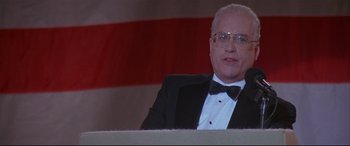 Movie still from “The American President” (1995), directed by Rob Reiner – An older man in a suit and bow tie; Close Up shot, Low angle