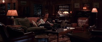 Movie still from “The American President” (1995), directed by Rob Reiner – A man and a woman sitting on a couch in a living room; Wide shot, High angle