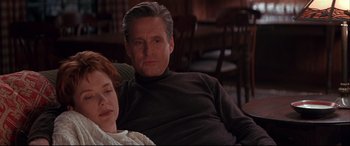 Movie still from “The American President” (1995), directed by Rob Reiner – A man and a woman sitting on a couch; Medium shot, Low angle