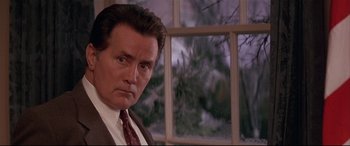 Movie still from “The American President” (1995), directed by Rob Reiner – A person wearing a suit and tie; Close Up shot, Low angle