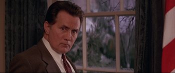 Movie still from “The American President” (1995), directed by Rob Reiner – A person wearing a suit and tie; Close Up shot, Low angle