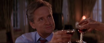 Movie still from “The American President” (1995), directed by Rob Reiner – A man holding a glass of wine in his right hand; Close Up shot, Low angle