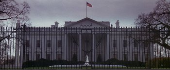 Movie still from “The American President” (1995), directed by Rob Reiner – The white house is seen through the fence; Extreme Wide shot, Low angle
