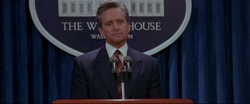 Movie still from “The American President” (1995), directed by Rob Reiner – A man standing at a podium in front of the white house; Close Up shot, Low angle