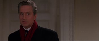 Movie still from “The American President” (1995), directed by Rob Reiner – A man in a black suit and a red scarf; Close Up shot, Over the shoulder angle