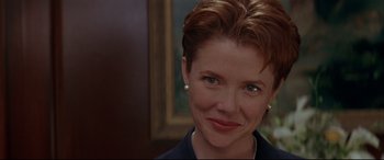 Movie still from “The American President” (1995), directed by Rob Reiner – A person wearing a necklace; Close Up shot, Over the shoulder angle