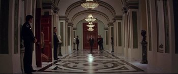Movie still from “The American President” (1995), directed by Rob Reiner – A group of people standing in a hallway; Extreme Wide shot, High angle