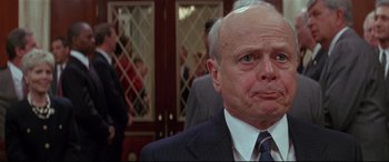 Movie still from “The American President” (1995), directed by Rob Reiner – An older man wearing a suit and tie in front of people; Close Up shot, Low angle