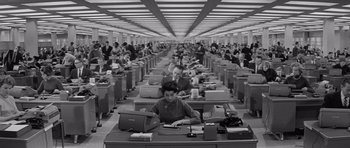 Movie still from “The Apartment” (1960), directed by Billy Wilder – An old photo of people sitting at desks in a room; Wide shot, High angle