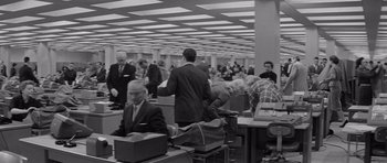Movie still from “The Apartment” (1960), directed by Billy Wilder – A black and white photo of people in an office setting; Wide shot, Low angle