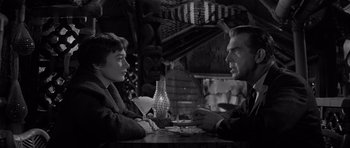 Movie still from “The Apartment” (1960), directed by Billy Wilder – A man and a woman sitting at a table in a restaurant; Medium shot, Over the shoulder angle