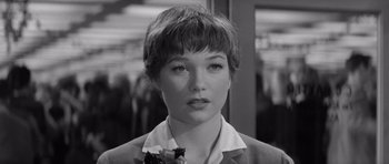 Movie still from “The Apartment” (1960), directed by Billy Wilder – A black and white photo of a woman with short hair; Close Up shot, Over the shoulder angle