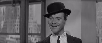 Movie still from “The Apartment” (1960), directed by Billy Wilder – A person wearing a hat and a suit; Close Up shot, Low angle