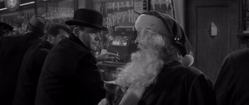 Movie still from “The Apartment” (1960), directed by Billy Wilder – A man in a hat and a beard is talking to an old man; Close Up shot, Low angle
