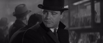 Movie still from “The Apartment” (1960), directed by Billy Wilder – A black and white photo of a man wearing a top hat; Close Up shot, Low angle