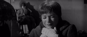 Movie still from “The Apartment” (1960), directed by Billy Wilder – A young woman crying with her hand over her mouth; Close Up shot, Low angle