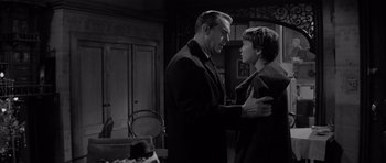 Movie still from “The Apartment” (1960), directed by Billy Wilder – A man and a young woman in an old photo; Medium shot, Over the shoulder angle