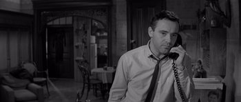 Movie still from “The Apartment” (1960), directed by Billy Wilder – A black and white photo of a man in a room; Close Up shot, Low angle