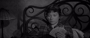 Movie still from “The Apartment” (1960), directed by Billy Wilder – A woman holding a deck of playing cards in her hands; Close Up shot, High angle