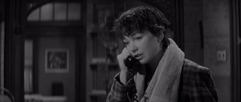 Movie still from “The Apartment” (1960), directed by Billy Wilder – A woman talking on a phone while wearing a towel; Close Up shot, High angle