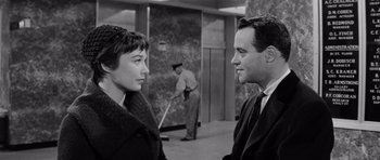 Movie still from “The Apartment” (1960), directed by Billy Wilder – A man and a woman talking in front of each other; Medium shot, Over the shoulder angle