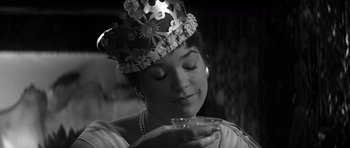 Movie still from “The Apartment” (1960), directed by Billy Wilder – A black and white photo of a woman wearing a crown; Close Up shot, High angle