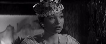 Movie still from “The Apartment” (1960), directed by Billy Wilder – A black and white photo of a woman wearing a crown; Close Up shot, High angle