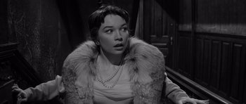Movie still from “The Apartment” (1960), directed by Billy Wilder – A black - and - white photo of a woman wearing a fur coat; Close Up shot, Low angle