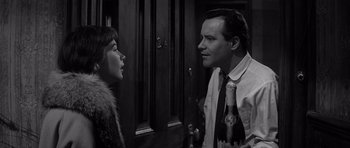 Movie still from “The Apartment” (1960), directed by Billy Wilder – A man and a woman standing next to each other; Close Up shot, Over the shoulder angle