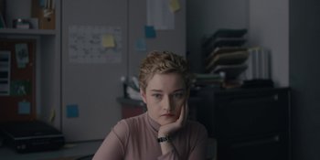 Movie still from “The Assistant” (2019), directed by Kitty Green – A woman sitting at a desk in front of papers; Close Up shot, High angle