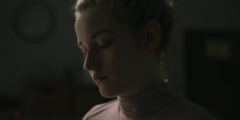 Movie still from “The Assistant” (2019), directed by Kitty Green – A young woman is looking down at her face; Close Up shot, Low angle