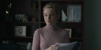 Movie still from “The Assistant” (2019), directed by Kitty Green – A woman in a pink shirt holding a paper; Close Up shot, Over the shoulder angle