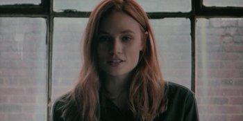 Movie still from “The Assistant” (2019), directed by Kitty Green – A person with long hair; Close Up shot, Low angle