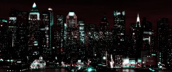 Movie still from “The Aviator” (2004), directed by Martin Scorsese – A view of a large city at night with lights on buildings; Extreme Wide shot, Low angle
