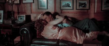 Movie still from “The Aviator” (2004), directed by Martin Scorsese – A man and a woman are laying on a couch; Medium shot, High angle