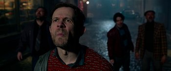 Movie still from “The BFG” (2016), directed by Steven Spielberg – A man in a red sweater standing next to another man in a red jacket; Close Up shot, Over the shoulder angle