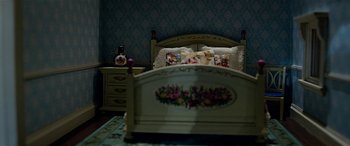 Movie still from “The BFG” (2016), directed by Steven Spielberg – A bed room with a bed and nightstand in it; Wide shot, High angle