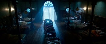 Movie still from “The BFG” (2016), directed by Steven Spielberg – A room filled with lots of luggage and a window; Extreme Wide shot, High angle