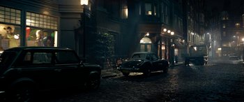 Movie still from “The BFG” (2016), directed by Steven Spielberg – A car parked on the side of the street at night; Wide shot, High angle